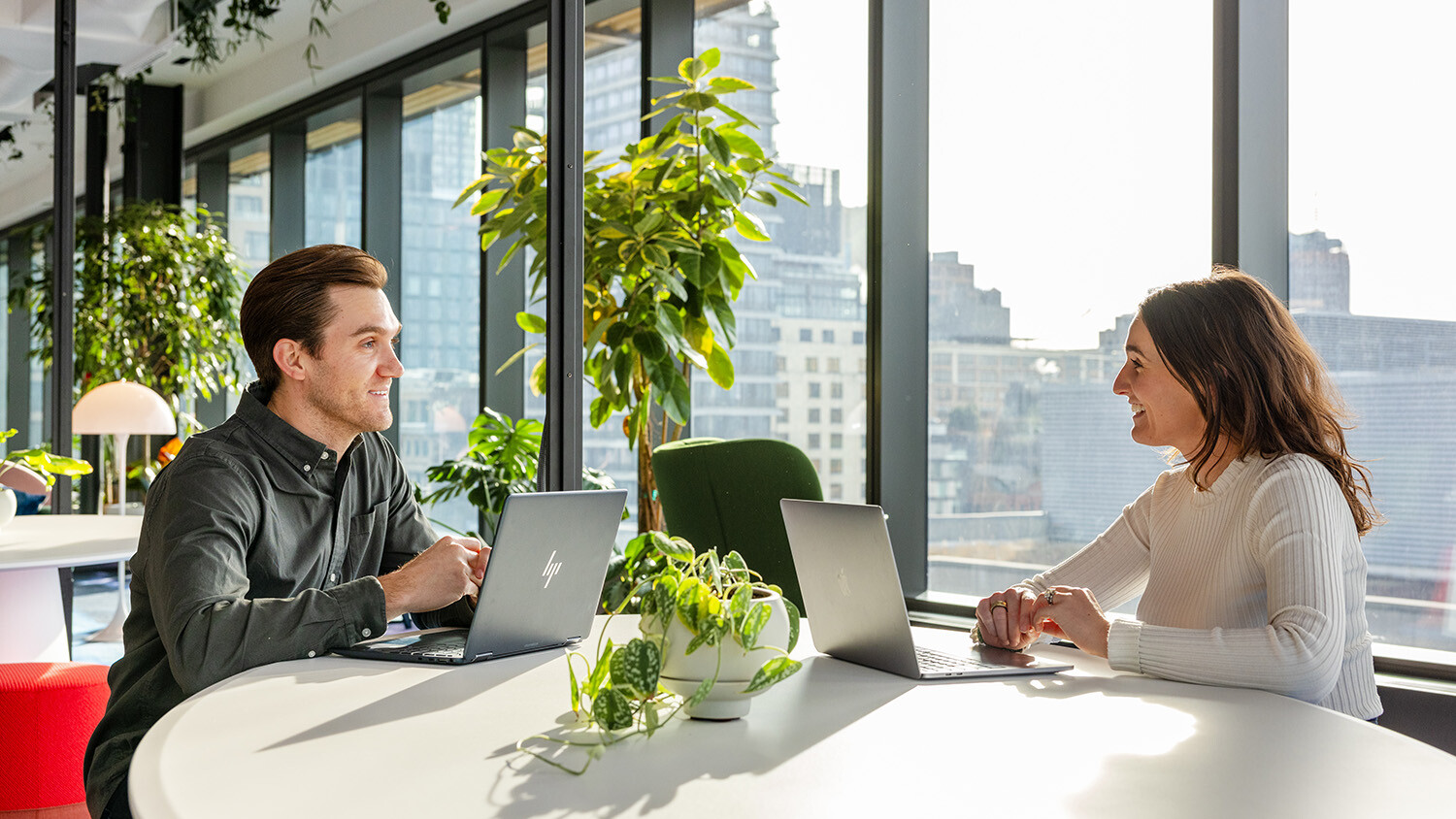 Two employees sitting and talking