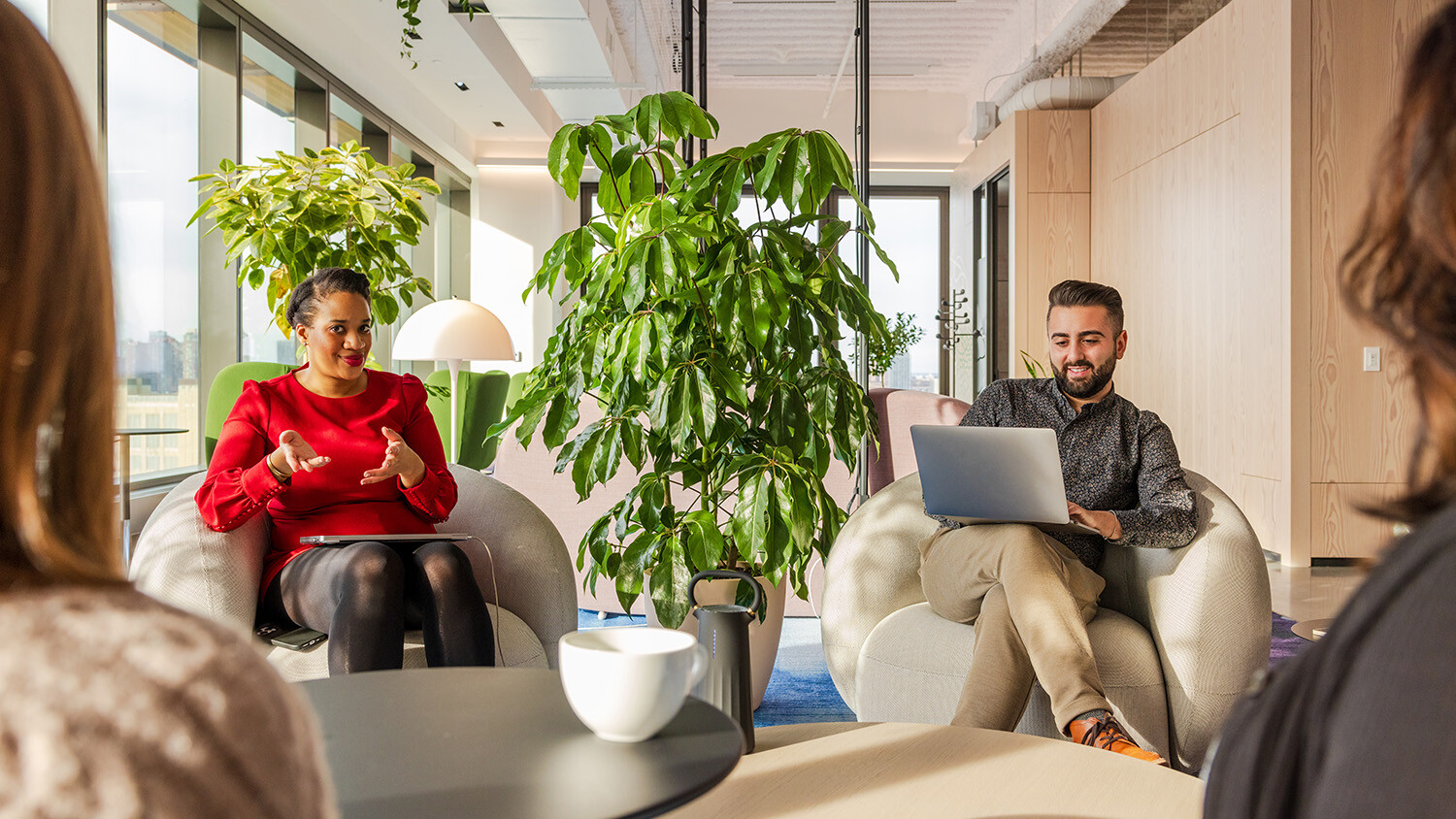 Employees collaborating in casual meeting space